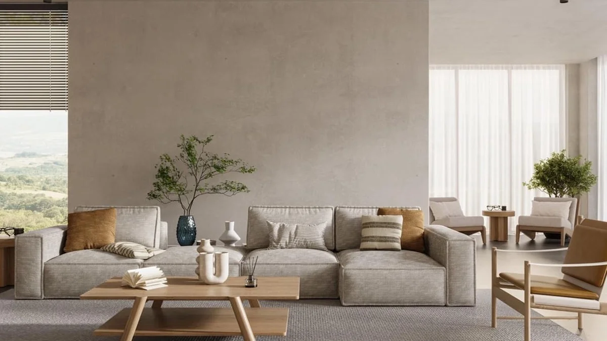 Personne ne place son canapé contre le mur : voici où les décorateurs le mettent en 2026 pour agrandir le salon